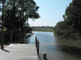 The dock on the water side. Fish, kayak, canoe, flat boat, all of the above.