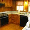 The Kitchen. Yes that is original Florida pine walls and floors. Plus all the stuff you need to cook your meals and  eat in at Bayou Cottage.